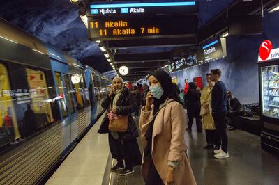 Stockholm metro passengers wait to board a train. The authorities are having difficulties persuading people to wear face masks on public transport. Getty Images