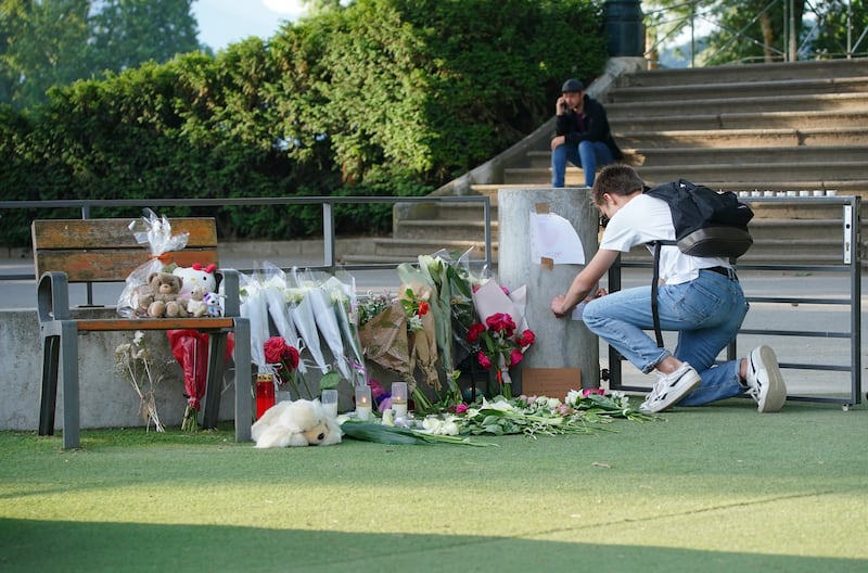 Tributes near the scene of the stabbing attack at a lakeside park in Annecy, France. PA