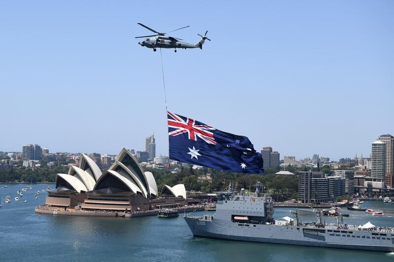 A Royal Australian Navy MH-60R Seahawk helicopter flies an Australian national flag over Sydney Harbour during Australia Day celebrations in Sydney, Australia.  EPA
