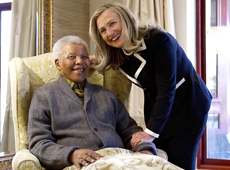 US Secretary of State Hillary Rodham Clinton meets with Nelson Mandela, 94, former president of South Africa, at his home in Qunu, South Africa, on August 6, 2012. Her private lunch with the Nobel Peace Prize winner was the first event of her South African visit, an indication of the prestige still enjoyed by the man who led the fight against white-minority rule. The two chatted in his home ahead of the meal, an honour that few receive as Mandela's health has become more fragile with age.  AFP PHOTO/POOL/ Jacquelyn Martin (Photo by JACQUELYN MARTIN / POOL / AFP)
