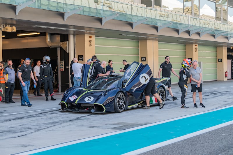 Drivers climb aboard a Huayra in Yas's pit lane
