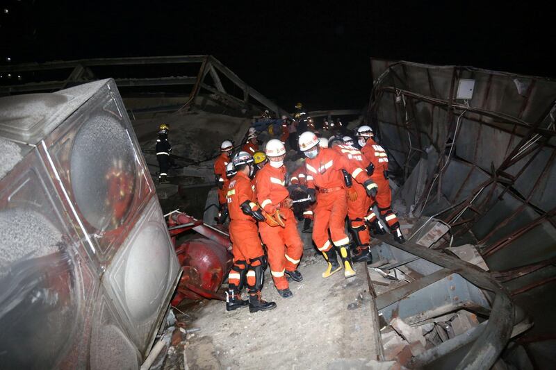 Rescue workers at the site where a hotel being used for coronavirus quarantine collapsed in the south-east Chinese port city of Quanzhou, Fujian province. Reuters