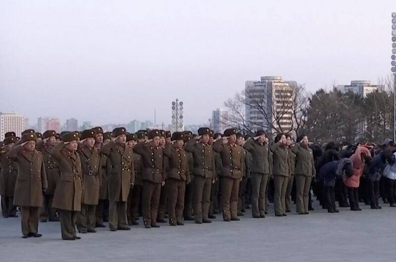 North Korean military personnel salute as they lay flowers in front of giant statues of Kim Il Sung and Kim Jong Il on Mansu Hill in central Pyongyang, Thursday, Feb. 8, 2018.  North Korea held a military parade and rally on Kim Il Sung Square on Thursday, just one day before South Korea holds the opening ceremony for the Pyeongchang Winter Olympics. KRT / AP