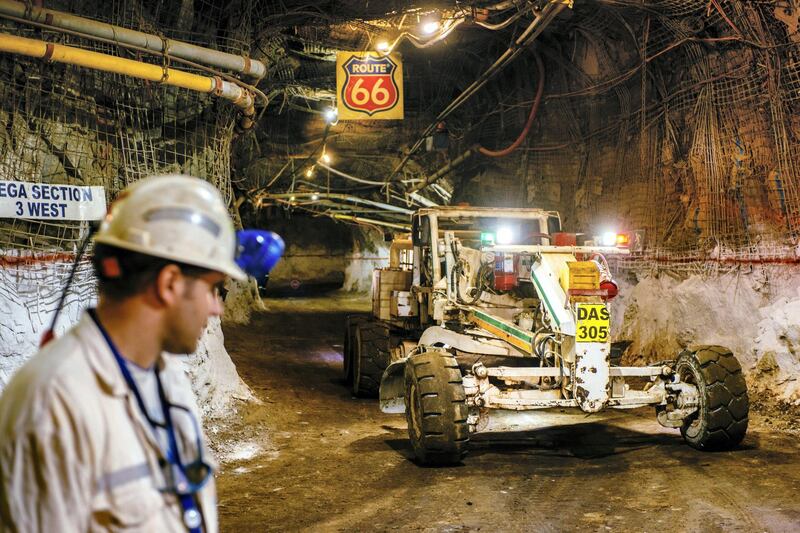 Heavy lifting equipment passes through an underground tunnel displaying a 'Route 66' highway sign at the South Deep gold mine, operated by Gold Fields Ltd., in Westonaria, South Africa, on Thursday, March 10, 2017. South Deep is the world's largest gold deposit after Grasberg in Indonesia, makes up 60 percent of the company's reserves and the miner says it's capable of producing for 70 years. Photographer: Waldo Swiegers/Bloomberg