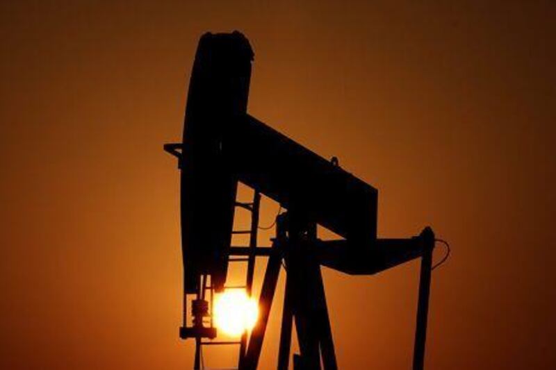An oil pump at sunset in Sakhir, Bahrain. The IMF has downgraded the Mena region's growth outlook without giving a reason. Hasan Jamali / AP Photo