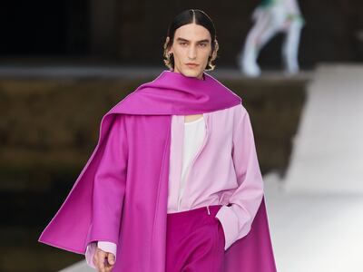 A caped men's look from Valentino haute couture in tones of raspberry, flamingo pink and fuchsia. Courtesy Valentino