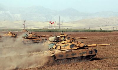 Turkish army tanks move during exercises in Silopi, near the Habur border gate with Iraq, southeastern Turkey, Monday, Sept. 25, 2017. Turkey's President Recep Tayyip Erdogan threatened military intervention in response to Iraqi Kurdish region's referendum on independence. Erdogan on Monday said Turkey would take political, economic as well as military measures against Iraqi Kurds' steps toward independence and also suggested that Turkey could halt oil flows from a pipeline from northern Iraq.(DHA-Depo Photos via AP )