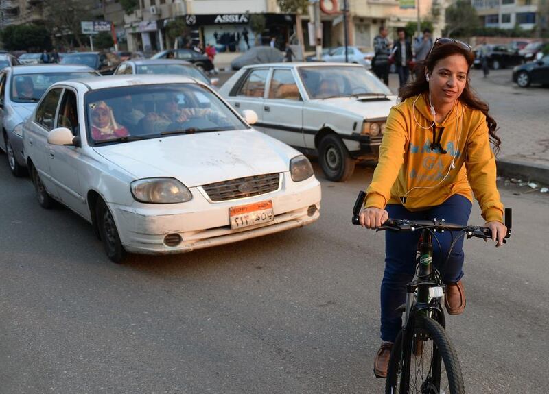 Egyptian Yasmine Mahmoud, a 31-year-old executive secretary, rides her bicycle in Cairo on December 25, 2014. Mohamed El Shahed/AFP Photo

