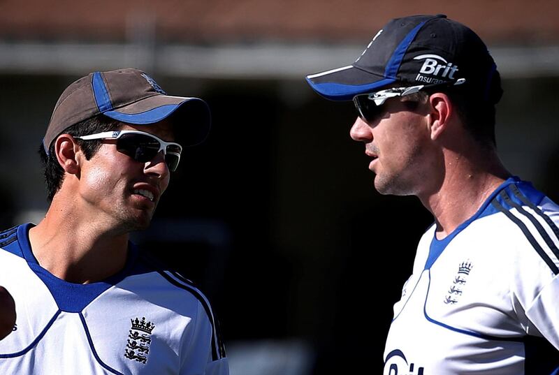 FILE PHOTO: England cricket team captain Alastair Cook (L) talks with teammate Kevin Pietersen during a team training session at the Basin Reserve in Wellington March 12, 2013. England will play New Zealand in the second test starting March 14. REUTERS/David Gray/File Photo