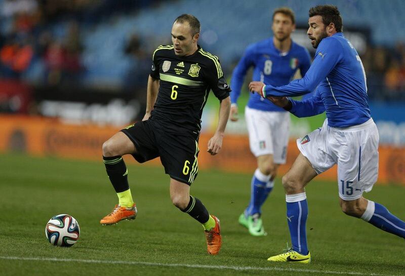 Andres Iniesta and Spain beat Italy 1-0. They'll play in Group B at the 2014 World Cup with Netherlands, Chile and Australia. Paul White / AP