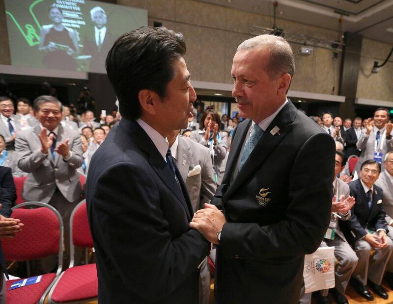 Turkish Prime Minister Tayyip Erdogan (R) congratulates Prime Minister Shinzo Abe of Japan after Jacques Rogge President of the International Olympic Committee (IOC) announced Tokyo as the city to host the 2020 Summer Olympic Game during a ceremony in Buenos Aires September 7, 2013.        REUTERS/Ian Walton/Pool (ARGENTINA - Tags: SPORT OLYMPICS POLITICS) *** Local Caption ***  BAS370_OLYMPICS-202_0907_11.JPG