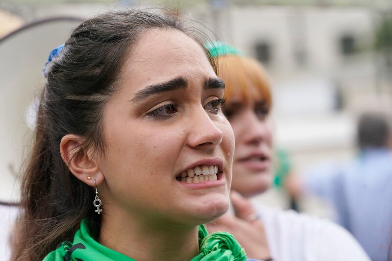 A woman reacts after hearing the abortion decision. AP