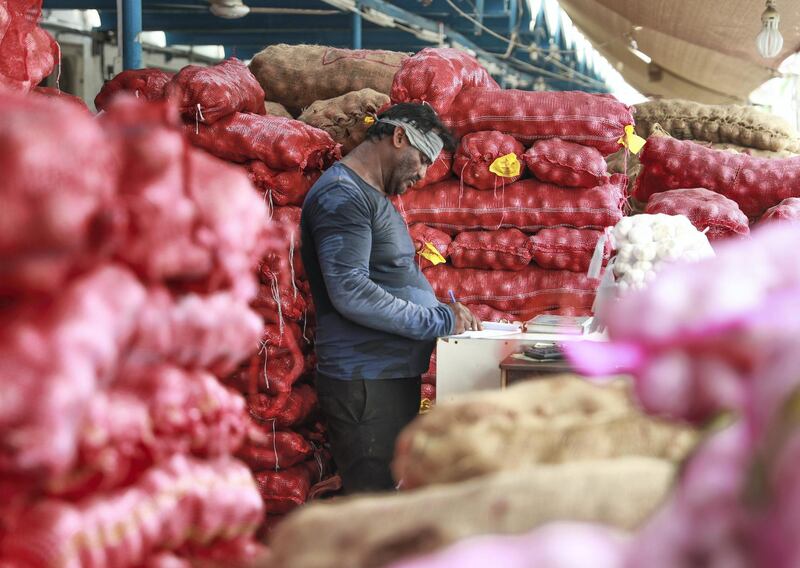 Abu Dhabi, U.A.E., July 30, 2018.   Fruits and Vegetable Market at Al Mina.  --  Abdul Kadar Kavgari checks the vegetable order list.
Victor Besa / The National
Section:  NA
Reporter:  Anna Zacharias