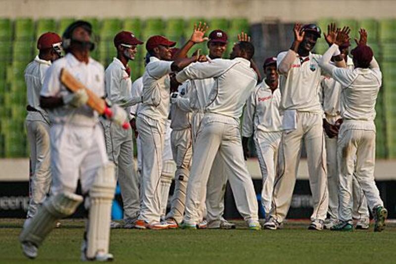 West Indies players celebrate the wicket of Banglades batsman Raqibul Hasan on their way to winning the second Test by 229 runs to secure their first away series win in eight years.