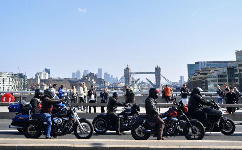Members ride across London Bridge in March 2022. AFP