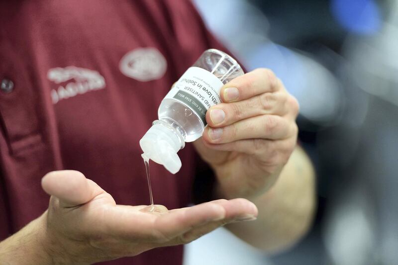 A worker uses hand sanitiser.