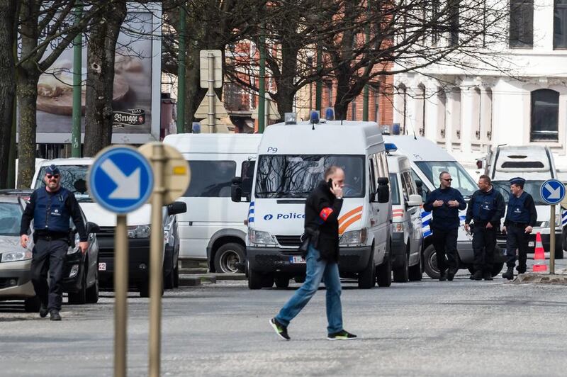 Police secure an area during a house search in the Etterbeek neighbourhood in Brussels on April 9, 2016. The arrest Friday of six men suspected of links to the Brussels bombings, including the last known fugitive in last year's Paris attacks, raised new questions about the extent of the ISIL cell believed to have carried out the intertwined attacks that left 162 people dead in two countries. Geert Vanden Wijngaert/AP Photo