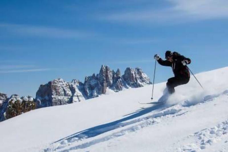 Skiing in the famous Cinque Torri in the Dolomites, northeastern Italy. EyesWideOpen / Getty Images