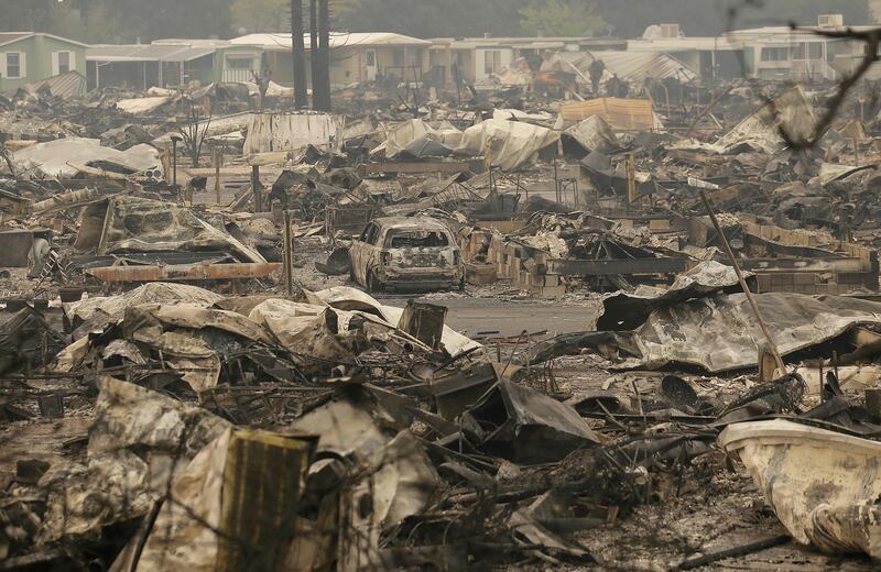 A car sits in the middle of property destroyed from fires at Journey's End mobile home park in Santa Rosa, California. Jeff Chiu / AP Photo