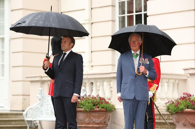 Britain's Prince Charles and French President Emmanuel Macron inspect a guard of honour from the Grenadier Guards at Clarence House in central London. AFP