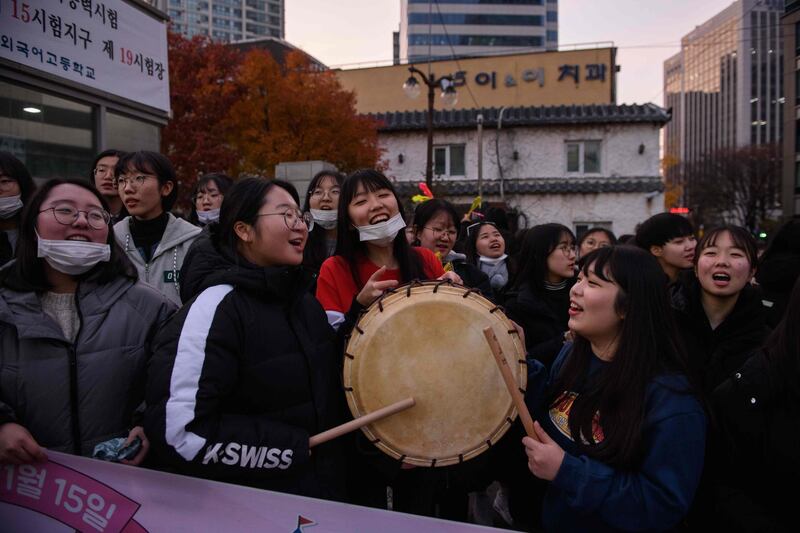 Students gather to cheer on others arriving outside the Ehwa Girls Foreign Language High School in Seoul, South Korea. AFP