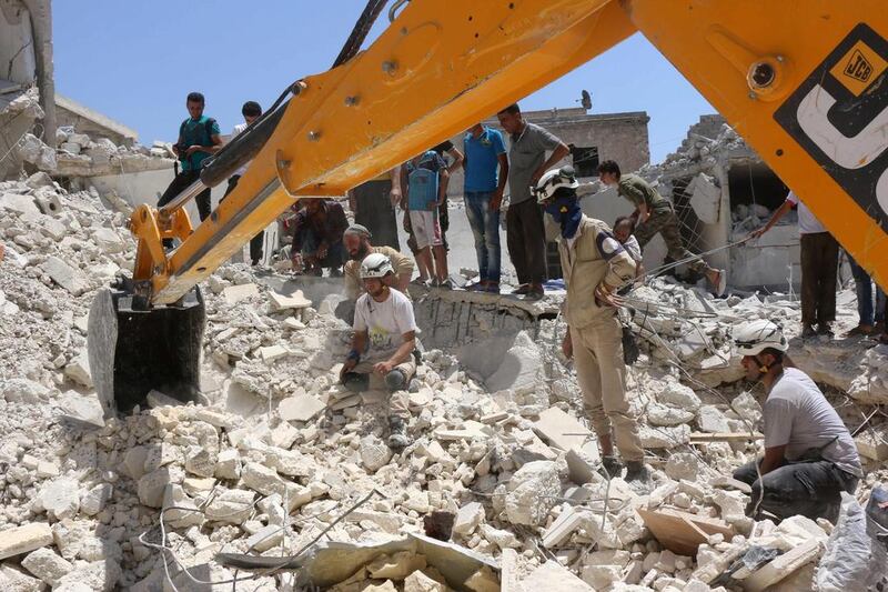 Syrian civil defence workers look for survivors under the rubble of a collapsed building following reported air strikes on July 17, 2016 in the rebel-controlled neighbourhood of Karm Homad in the northern city of Aleppo. Thaer Mohammed/AFP