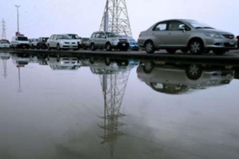 Rain disrupts traffic in Dubai and prompts flash flood warnings.