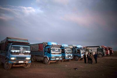 Trucks wait to receive surrendering ISIS fighters and civilians, outside Baghouz ,Syria, 7 March 2019.