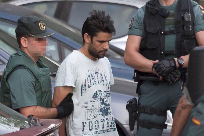 Mohamed Aallaa, suspected of involvement in the terror cell that carried out twin attacks in Spain, is escorded by Spanish Civil Guards from a detention center in Tres Cantos, near Madrid, on August 22, 2017 before being tranferred to the National Court.
Under heavy security, police vans entered the National Court, which deals with terrorism cases, where a judge will question them and decide what -- if any -- charges to press against them over the vehicle attacks that left 15 dead and 120 injured. / AFP PHOTO / STRINGER