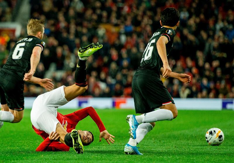 Manchester United's Andreas Pereira, left, and AZ Alkmaar's Yukinari Sugawara, right, during the Europa League match at Old Trafford.  EPA