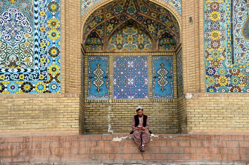 An Afghan Muslim reads the Quran outside a mosque during the holy month of Ramadan in Herat Province. Muslims throughout the world are marking the month of Ramadan, the holiest month in the Islamic calendar during which Muslims fast from dawn until dusk. Hoshang Hashimi / AFP