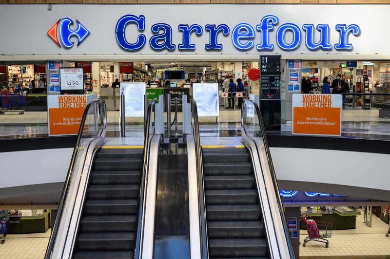 (FILES) In this file photo taken on November 03, 2020 this picture shows the entrance of a Carrefour supermarket in Rosny-sous-Bois. French retail giant Carrefour said January 12, 2021, it was approached by Canadian group Couche-Tard for a "rapprochement". "The discussions are very preliminary," Carrefour said in a succinct statement, while specifying that Couche-Tard's approach was "friendly". / AFP / BERTRAND GUAY
