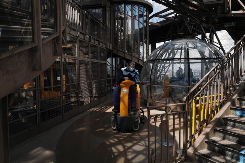 Tour Eiffel employee drives a cleaning machine at the first floor during a presentation of the security measures at the Eiffel Tower in Paris. AP