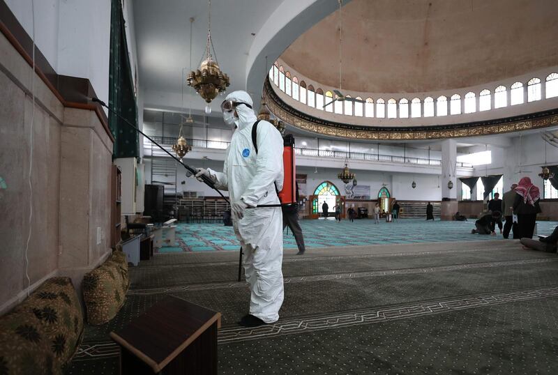 A volunteer from the Violet organisation disinfects a mosque in Syria's northwestern city of Idlib from coronavirus.   AFP