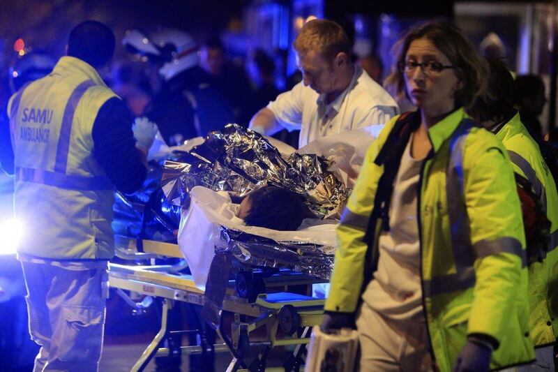 Emergency workers tending to the injured outside the Bataclan theatre. Thibault Camus/AP Photo