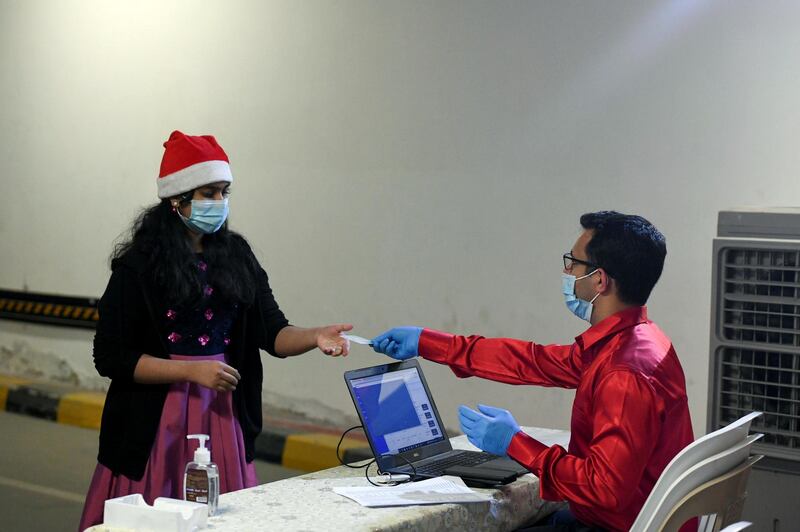 Abu Dhabi, United Arab Emirates - Counters have been set up so worshippers can validate online registrations by swiping their Emirates identity cards for midnight mass at St. PaulÕs Catholic Church, Mussafah. Khushnum Bhandari for The National

