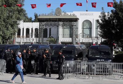 Police officers stand guard outside the Tunisian parliament building as the new assembly holds its first session in Tunis on March 13. EPA