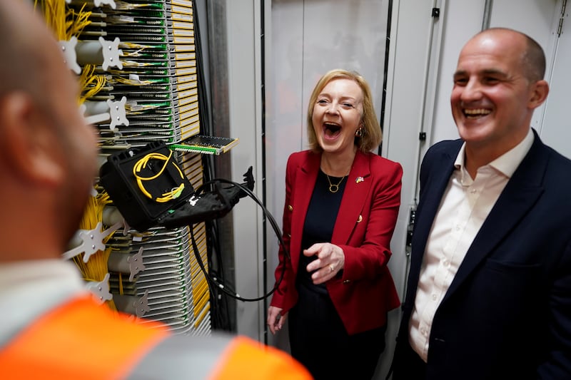 Ms Truss and Jake Berry, MP for Rossendale and Darwen, during a visit to a broadband interchange company in Leeds. PA