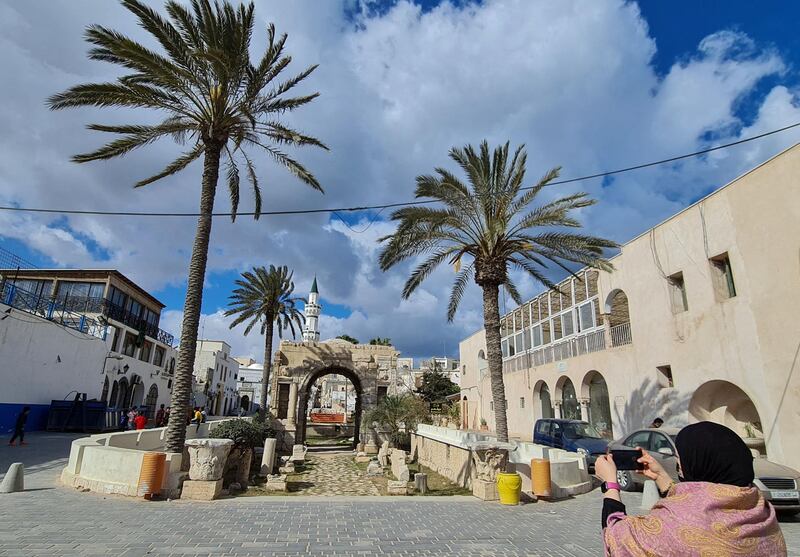 A woman takes pictures of Roman Arch of Marcus Aurelius at the entrance of Tripoli's Old City. AFP