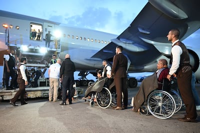 Etihad crew members help take the 16th group of wounded Palestinian children and cancer patients aboard a flight to Abu Dhabi from Al Arish for treatment, on April 26, 2024. Wam 