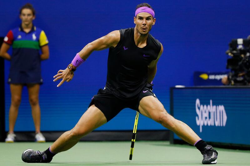 Rafael Nadal, of Spain, slides after running to return a shot to Marin Cilic, of Croatia, during the fourth round of the U.S. Open tennis tournament.  AP