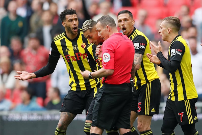 Watford's Jose Holebas and Etienne Capoue remonstrate with referee Kevin Friend after Manchester City captain Vincent Kompany appeared to handle in the area. The decision was reviewed by VAR but no penalty was given. Reuters