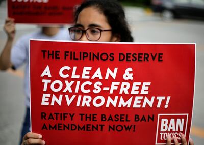 epa07611700 A Filipino environmental activist holds a placard during a demonstration in Manila, Philippines, 24 May 2019 (issued on 30 May 2019). In the midst of its 'garbage war' with Canada, the Philippines has found in its ports more waste containers from Australia and Hong Kong. The shipment to the Philippines of a hundred garbage containers from Canada six years ago - 69 containers of which depart on 30 May, back to their origin- has triggered in the last month a serious diplomatic conflict between the two nations and has ignited the debate on the export of non-recyclable waste to the developing world.  EPA/FRANCIS R. MALASIG