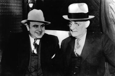 American gangster Al Capone, left, with US Marshall Laubenheimar. Getty