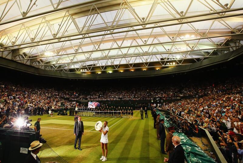 Petra Kvitova poses with the Venus Rosewater Dish trophyafter he win in the 2014 Wimbledon women's singles final on Saturday. Al Bello / Getty Images