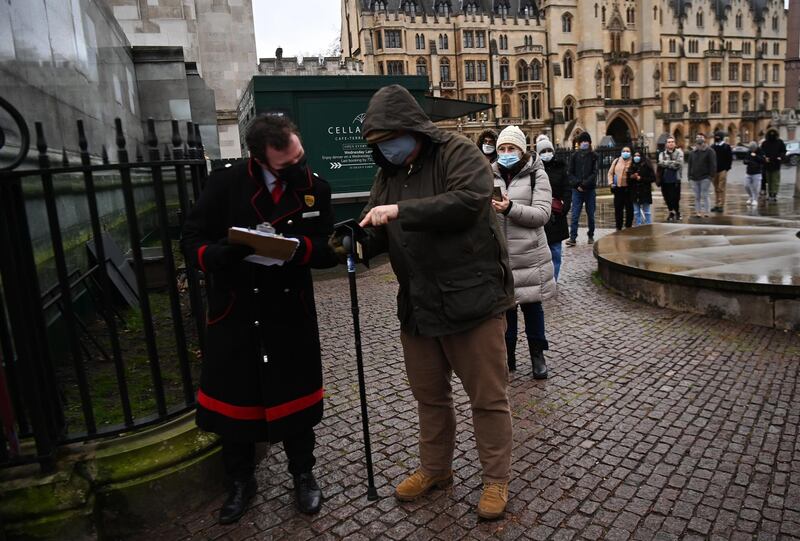 People queue up for vaccinations outside Westminster Abbey in London. EPA