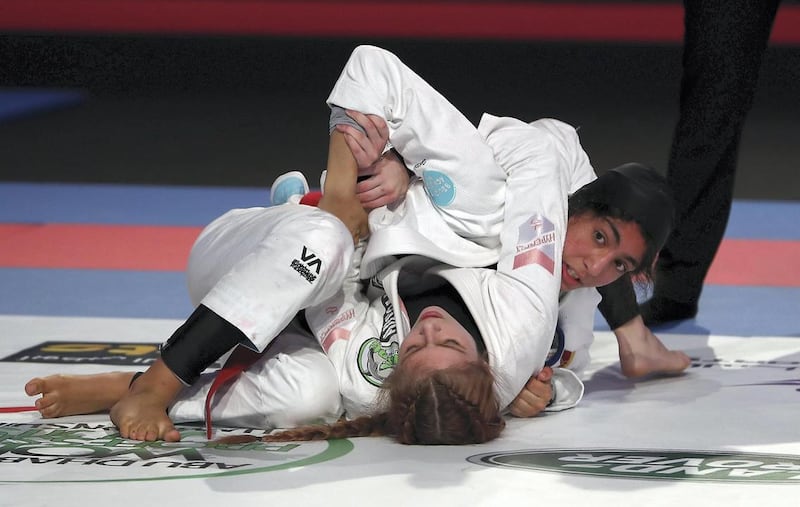 Shamma Al Kalbani (top) on her way to win the gold against Australian Brioni Cuskelly in the blue belt 52-kilogram final in the Jiu-Jitsu International Federation’s (IJJF) World Youth and Aspirants at the Mubadala Arena in Abu Dhabi on April 2019. Pawan Singh / The National