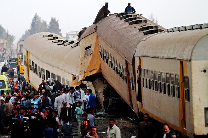 epa06570876 People inspect the wreckage of a passenger train that collided with a freight train in the village of Kom Hamada in the northern province of Beheira, Egypt, 28 February 2018. Reports state at least 15 people died and 40 injured in the accident that occurred when two passenger carriages disconnected from the rest of the train and collided with a freight train, the cause of which is still unknown.  EPA/STR