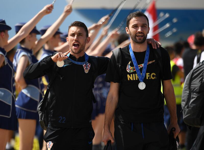 Croatian national football team members step out at the Zagreb international airport. Attila Kisbenedek / AFP