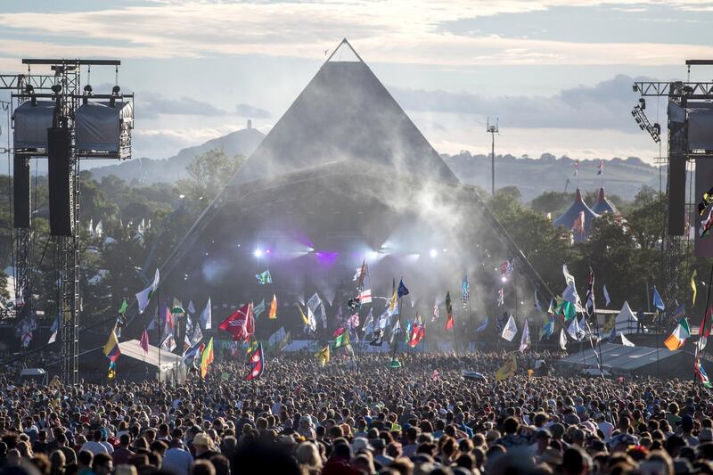 GLASTONBURY, ENGLAND - JUNE 25:  People gather in front of the Pyramid Stage  at Worthy Farm in Pilton on June 25, 2017 near Glastonbury, England. Glastonbury Festival of Contemporary Performing Arts is the largest greenfield festival in the world. It was started by Michael Eavis in 1970 when several hundred hippies paid just Â£1, and now attracts more than 175,000 people  (Photo by Matt Cardy/Getty Images)